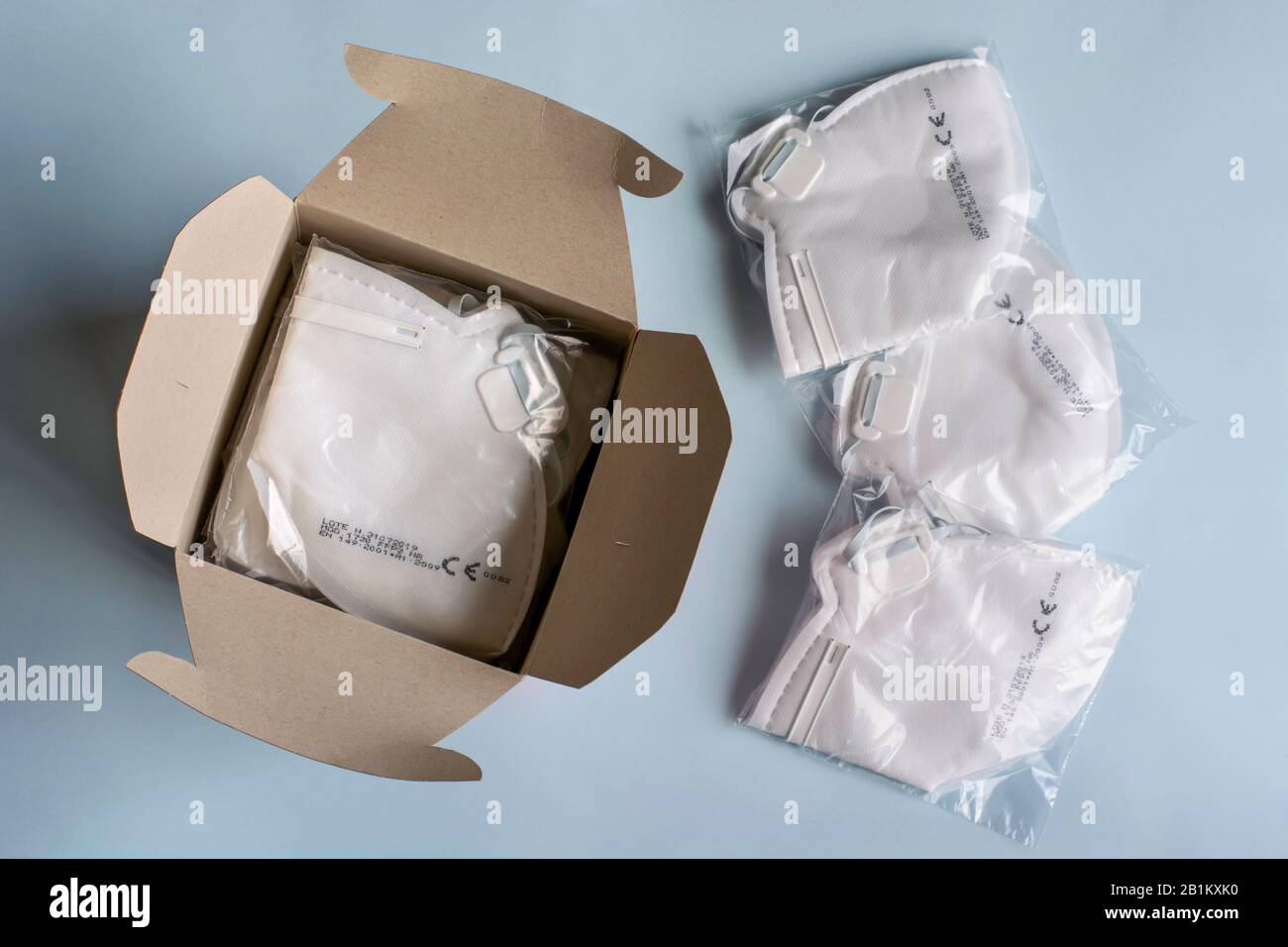 Filtering face mask. Box full of medical dust masks, disposable FFP3 respirators and with filter. Coronavirus, infectious diseases and precautions. Stock Photo