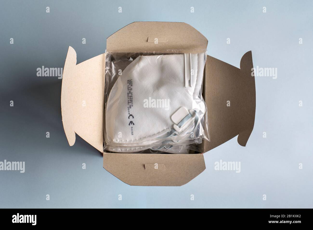 Filtering face mask. Box full of medical dust masks, disposable FFP3 respirators and with filter. Coronavirus, infectious diseases and precautions. Stock Photo