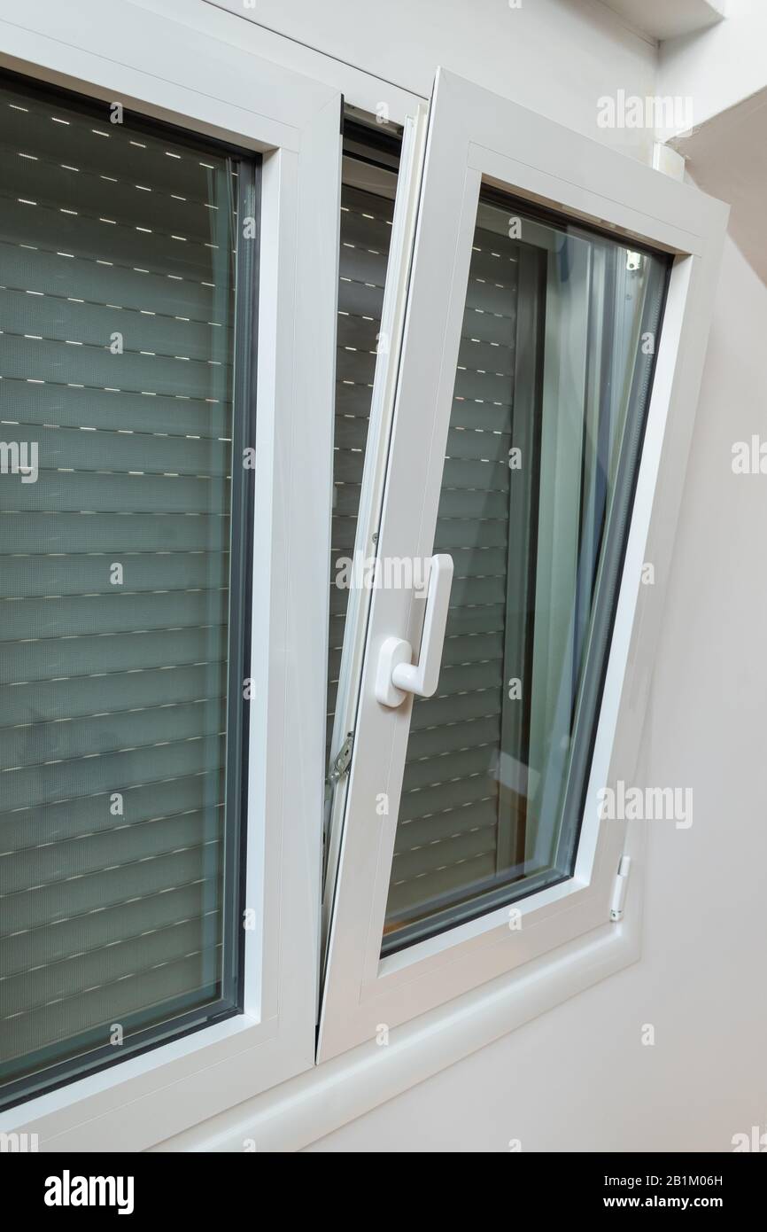 Double tilt and turn aluminum thermal break window with vertical fly screen  and rolling shutter, casement window with European groove mechanism Stock  Photo - Alamy