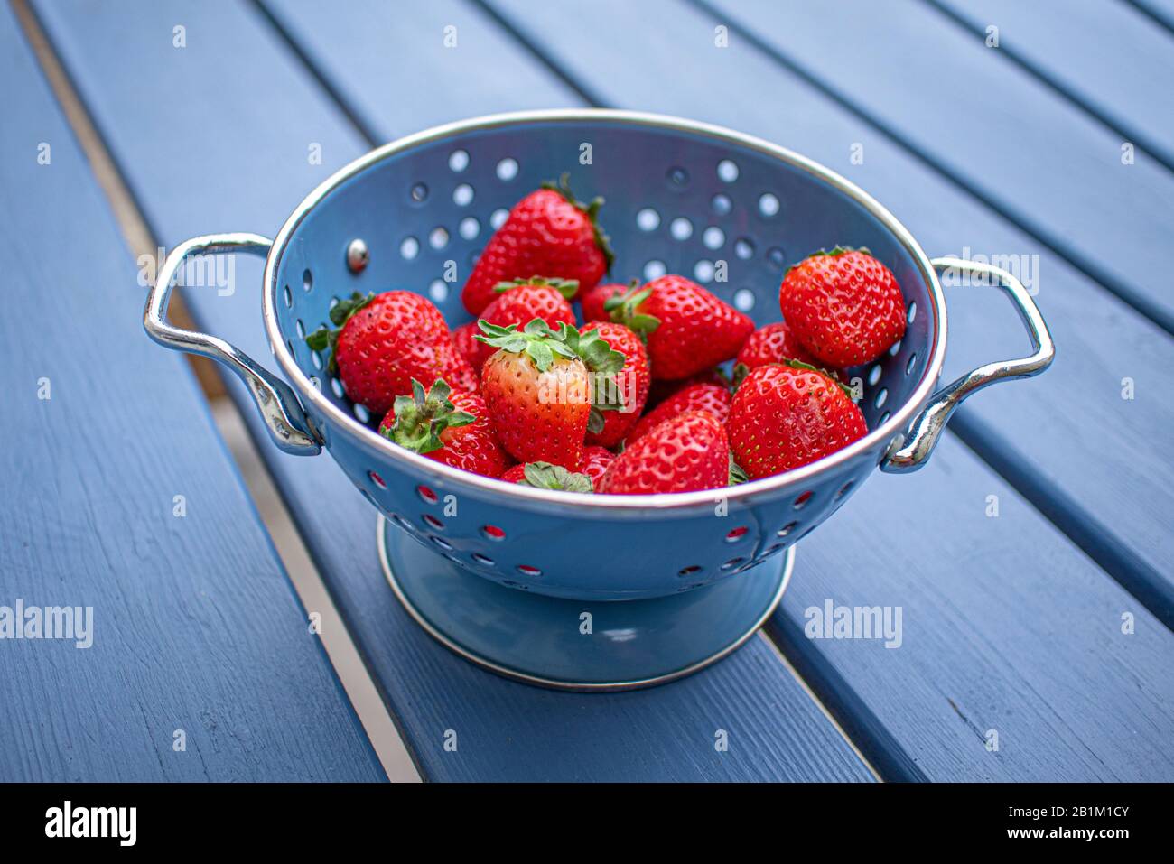 Strawberries in blue metal hi-res stock photography and images - Alamy