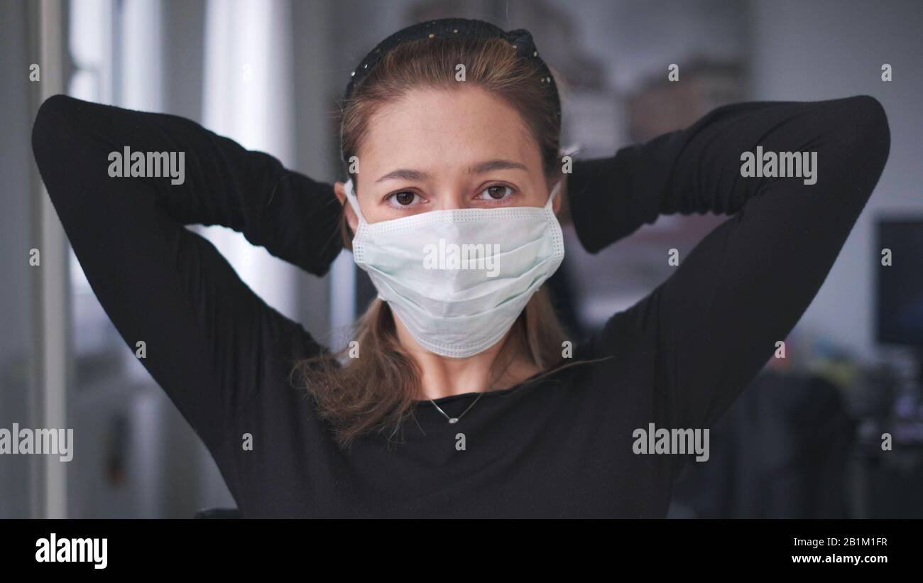 horizontal background of woman wearing surgical mask for corona virus isolation Stock Photo