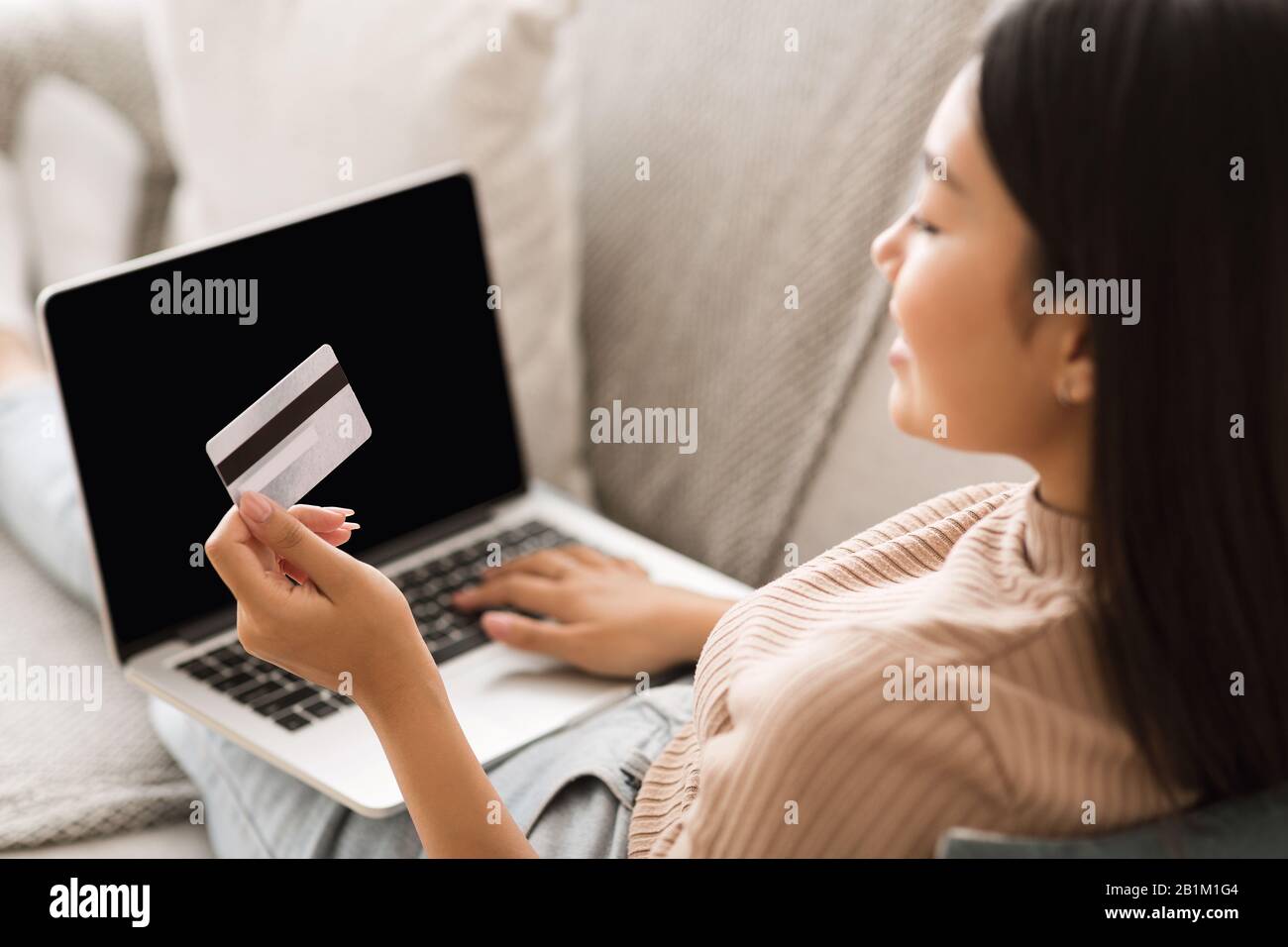 Order online. Girl making purchases on laptop computer Stock Photo
