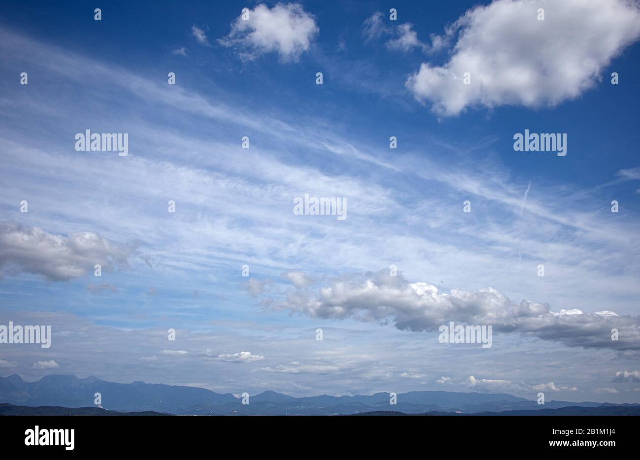 Blue sky with clouds beautiful mountains on background Stock Photo - Alamy