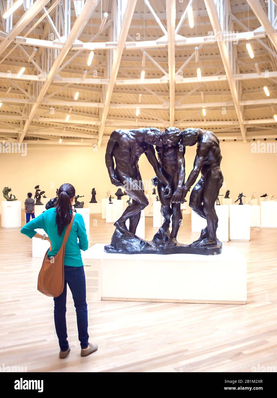 Adult looking at sculptureThe Three Shades by Aguste Rodin in the Soumaya Museum, Polanco, Mexico City, Mexico Stock Photo