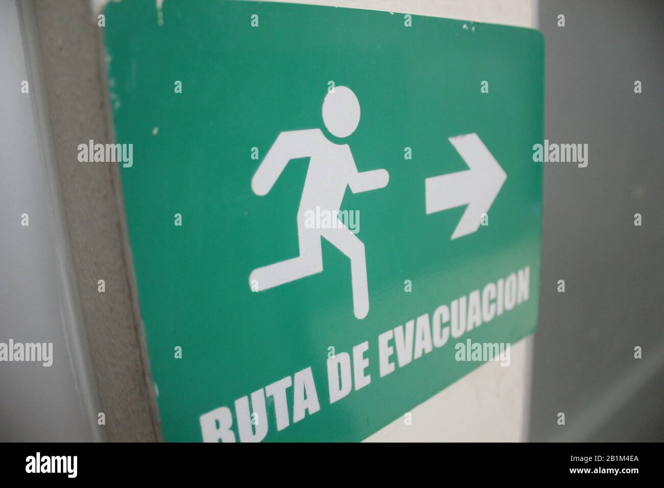 A green evacuation sign Stock Photo - Alamy