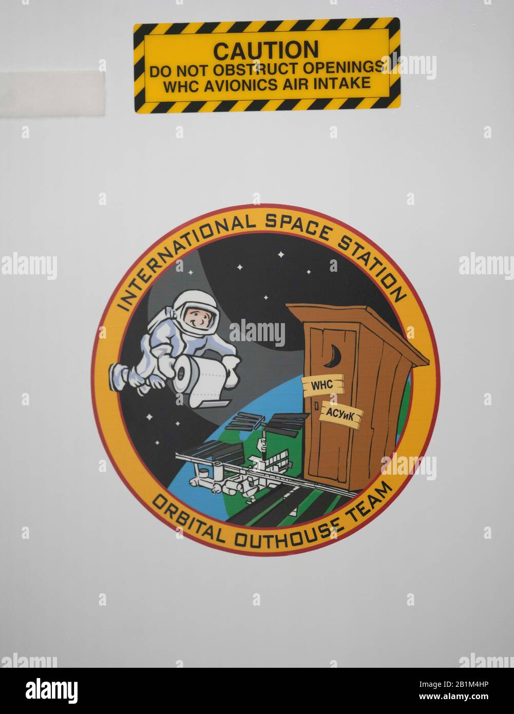 A humorous decal above the toilet facility in Node 3 of the International Space Station (ISS) at NASA's full-size mockup of the ISS at the Johnson Space Center. Stock Photo