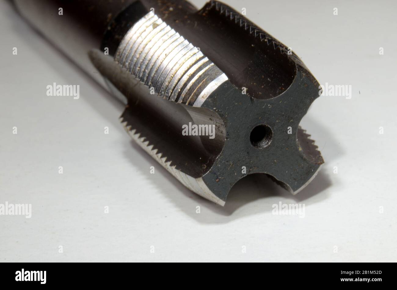 Closeup on the cutting edges of a larger thread cutting tap. Stock Photo