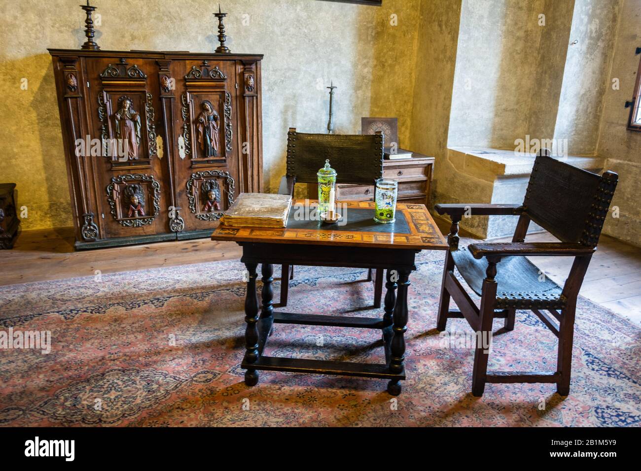 Karlstejn, Czech Republic – July 12, 2016. Interior view of a room at the Karlstejn medieval castle, with period furniture. Stock Photo