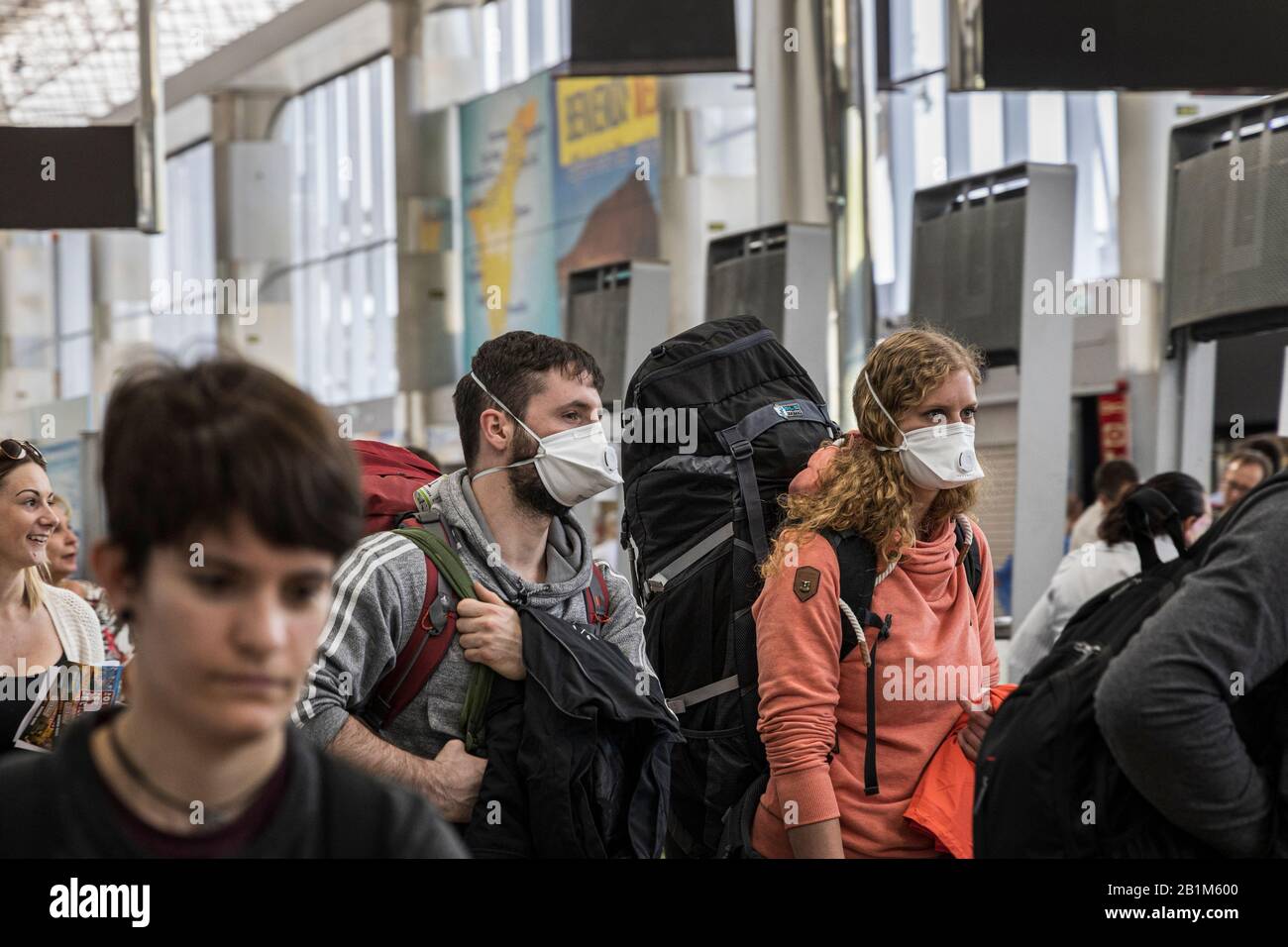 Tenerife South Airport, Canary Islands, 26th February 2020. Holidaymakers arriving at Tenerife South airport wearing face masks after the H10 Costa Adeje Palace hotel is put into a quarintine lockdown due to corona virus outbreak confirmed in four Italian tourists. Stock Photo