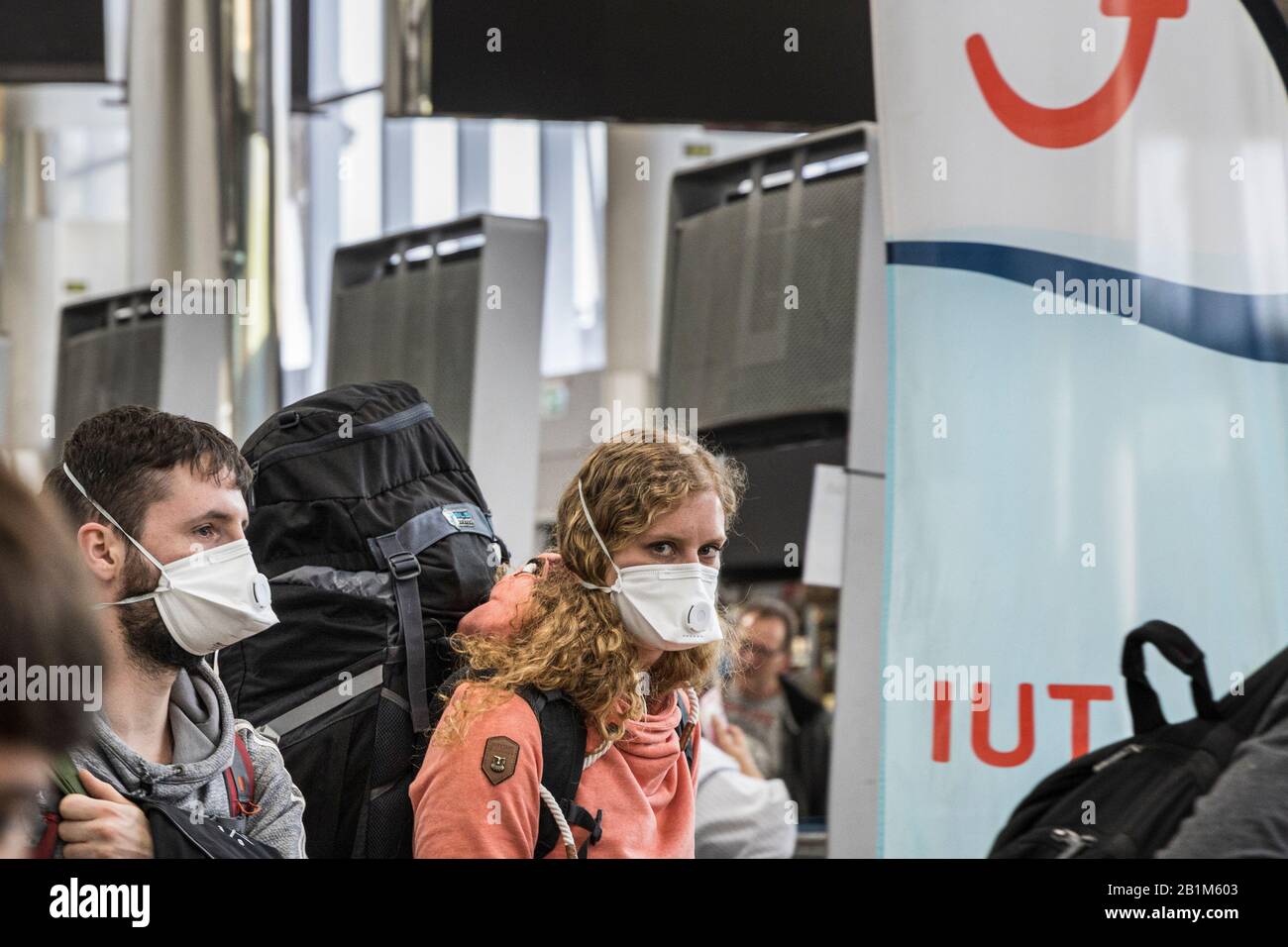 Tenerife South Airport, Canary Islands, 26th February 2020. Holidaymakers arriving at Tenerife South airport wearing face masks after the H10 Costa Adeje Palace hotel is put into a quarintine lockdown due to corona virus outbreak confirmed in four Italian tourists. Stock Photo