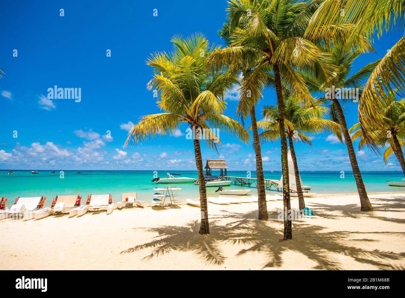 Trou aux biches Mauritius.Tropical exotic beach with palm trees and clear blue water. Stock Photo