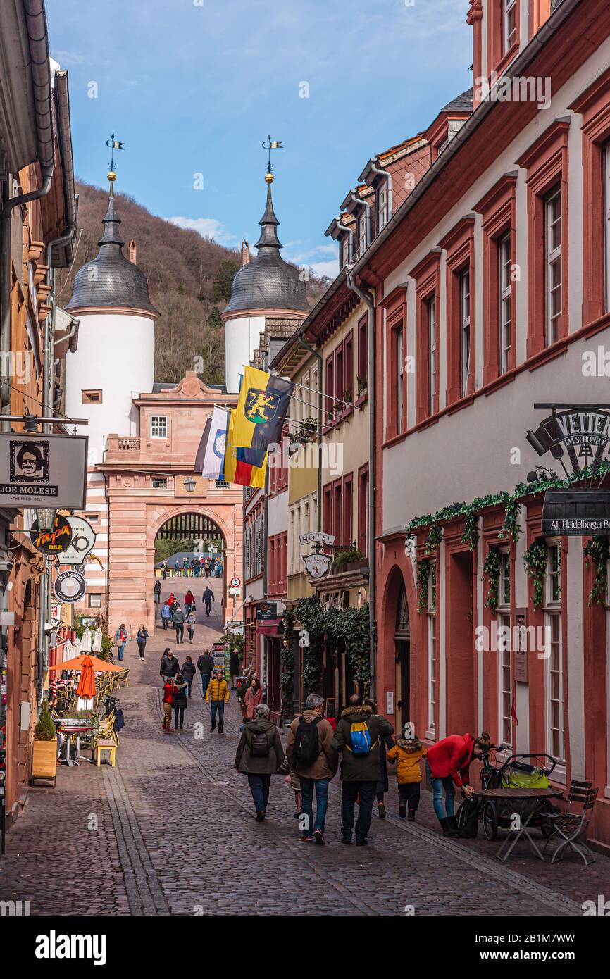 Heidelberg, Germany, February 22, 2020: Pedestrians in 'Steingasse' near town gate in Heidelbergs old town Stock Photo