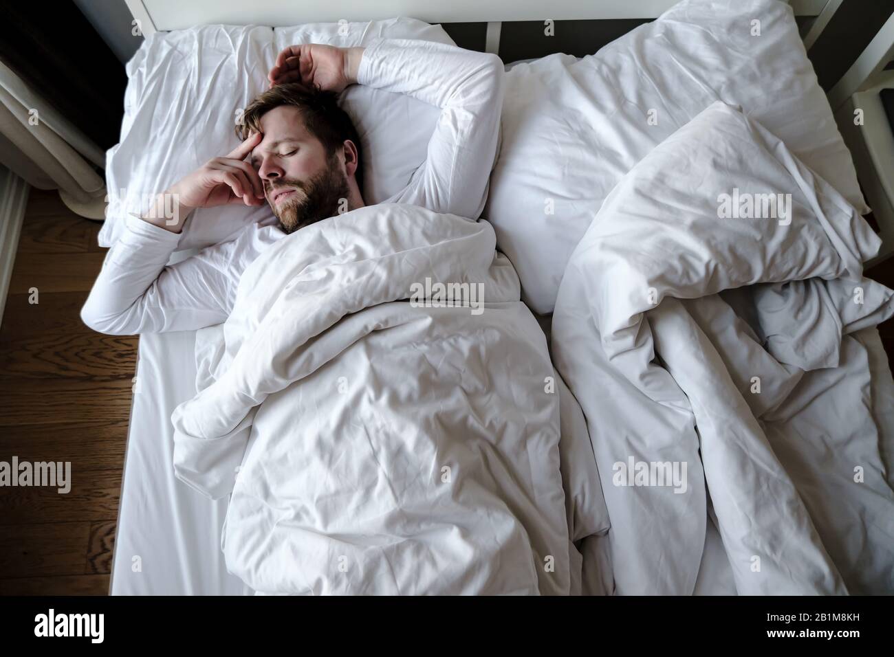 Bearded Man Sleeps Restlessly In Bed He Is Alarmed And Had A