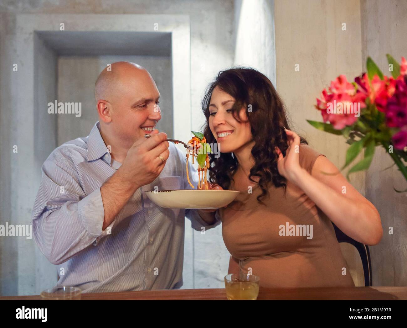 Husband feed wife kitchen hires stock photography and images Alamy