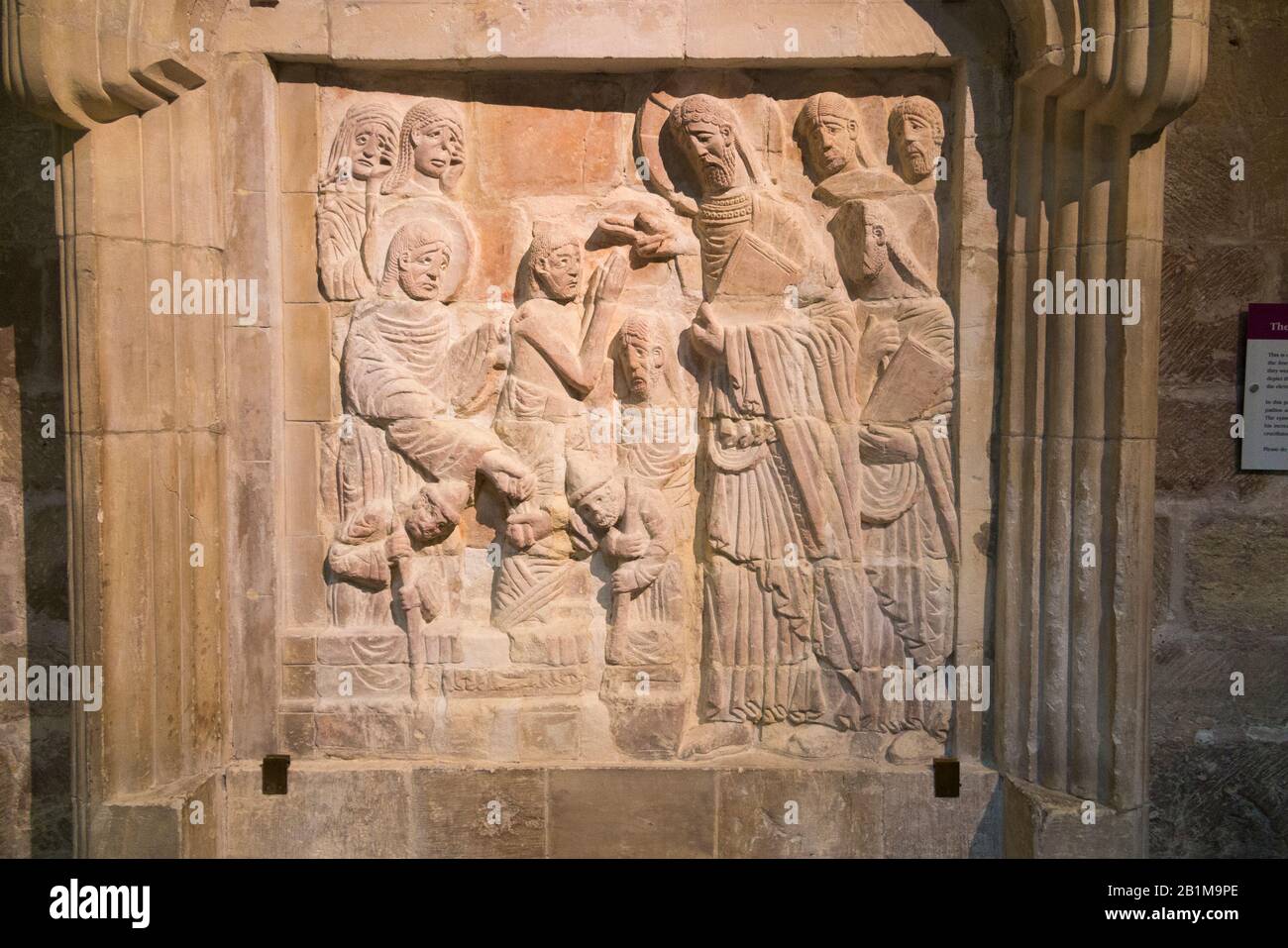 A Chichester Cathedral relief; the image of Christ arriving in Bethany and being greeted my Martha & Mary, the grieving sisters of Lazarus. UK (114) Stock Photo