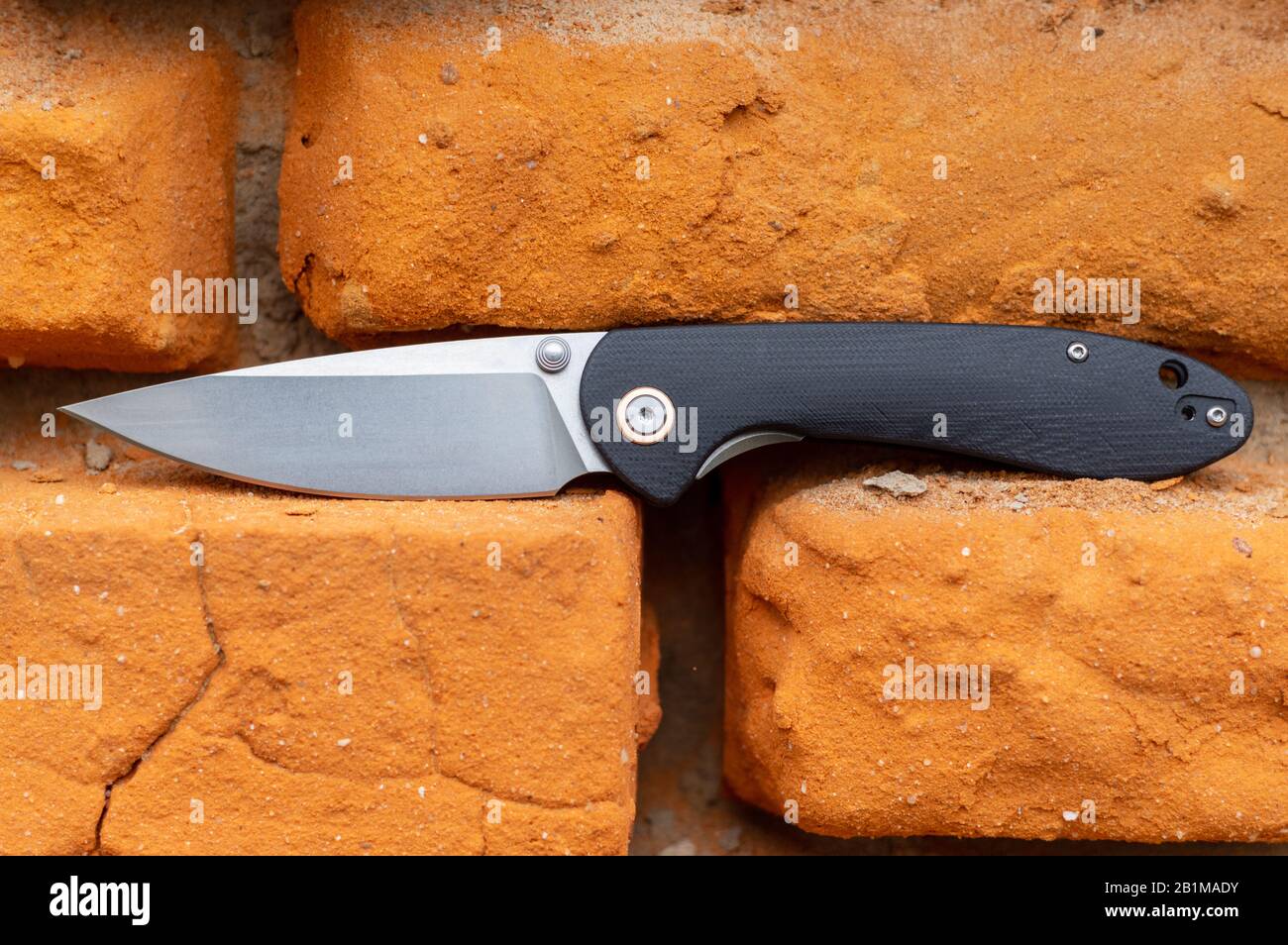 Knife in the brick wall. Red brick wall. Background of bricks Stock