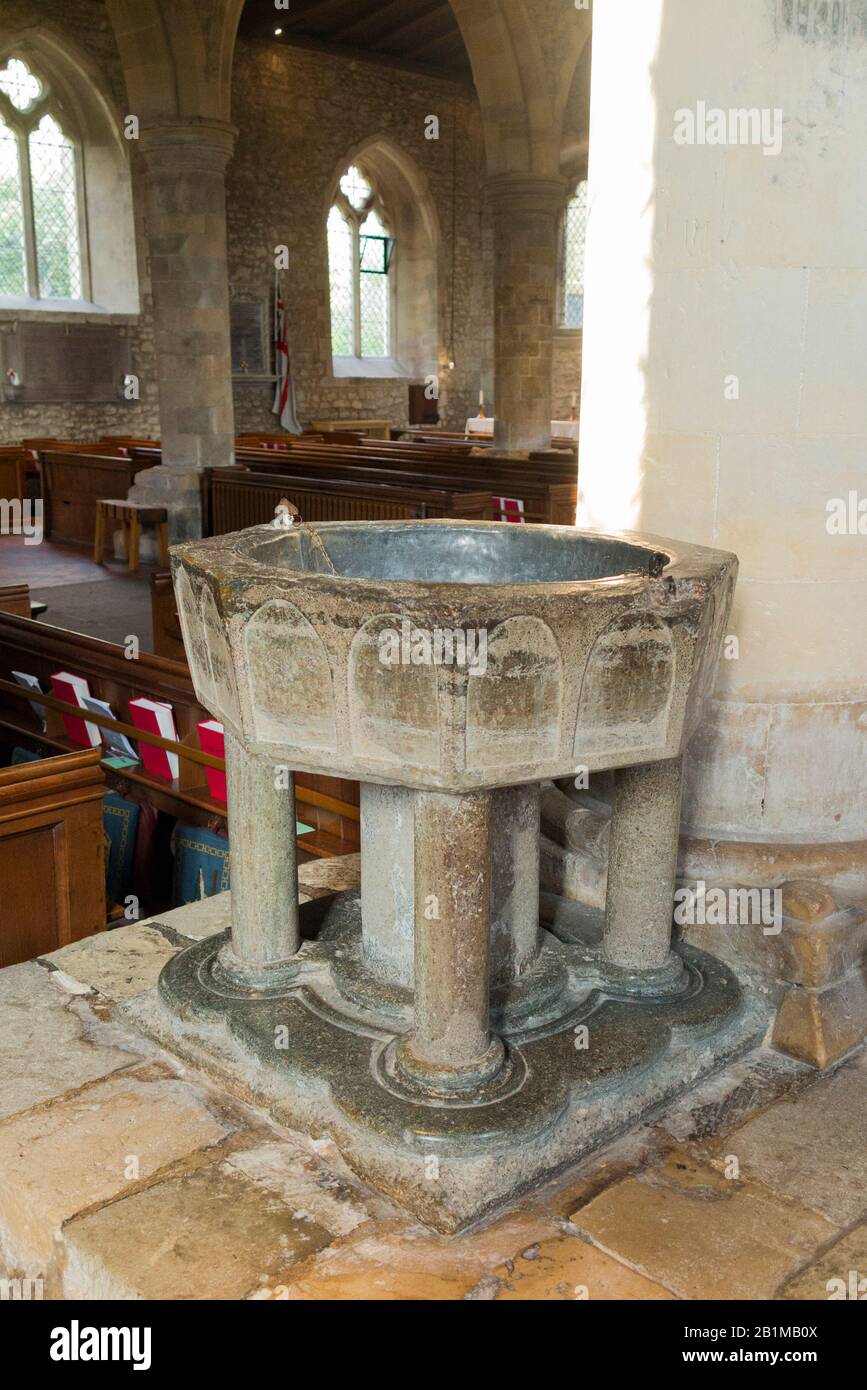Late Norman 12th century stone octagonal Baptismal font carved from Purbeck marble inside Bosham