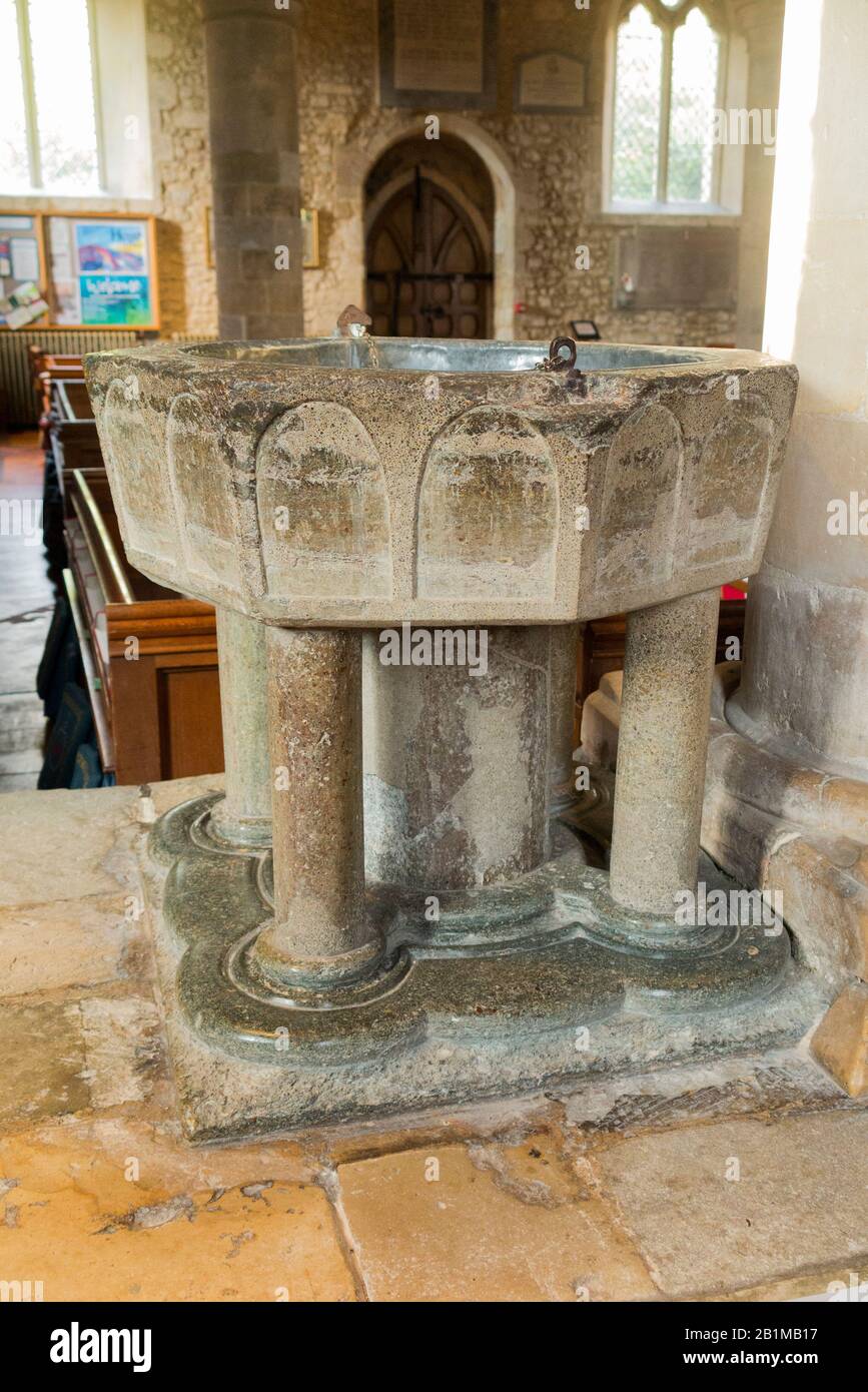 Late Norman 12th century stone octagonal Baptismal font carved from Purbeck marble inside Bosham