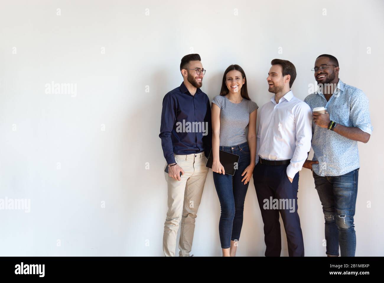 Millennial generation arab african european businesspeople posing isolated on grey Stock Photo