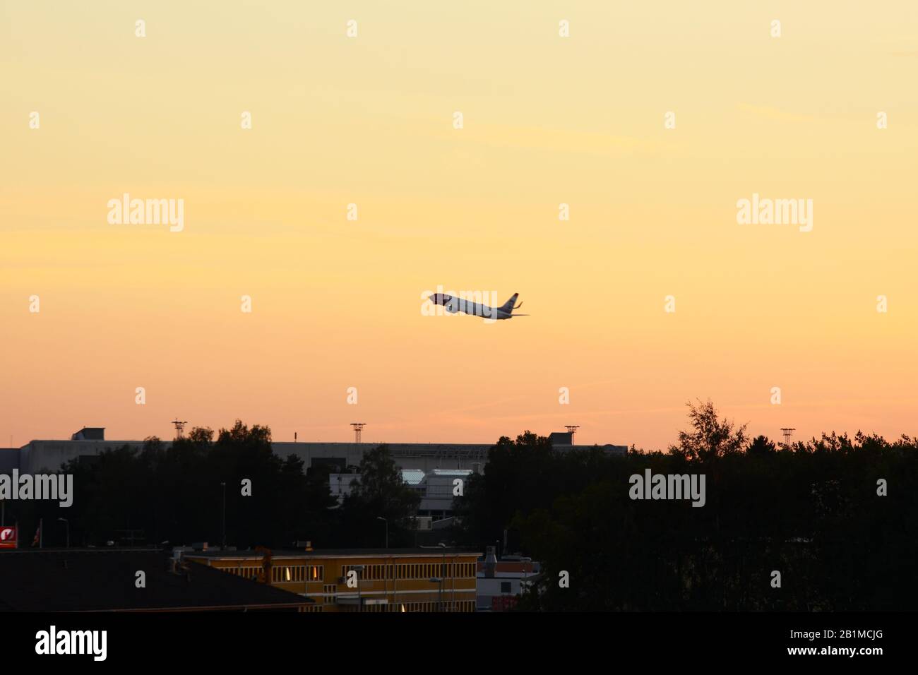 Airplane taking off in sunset Stock Photo