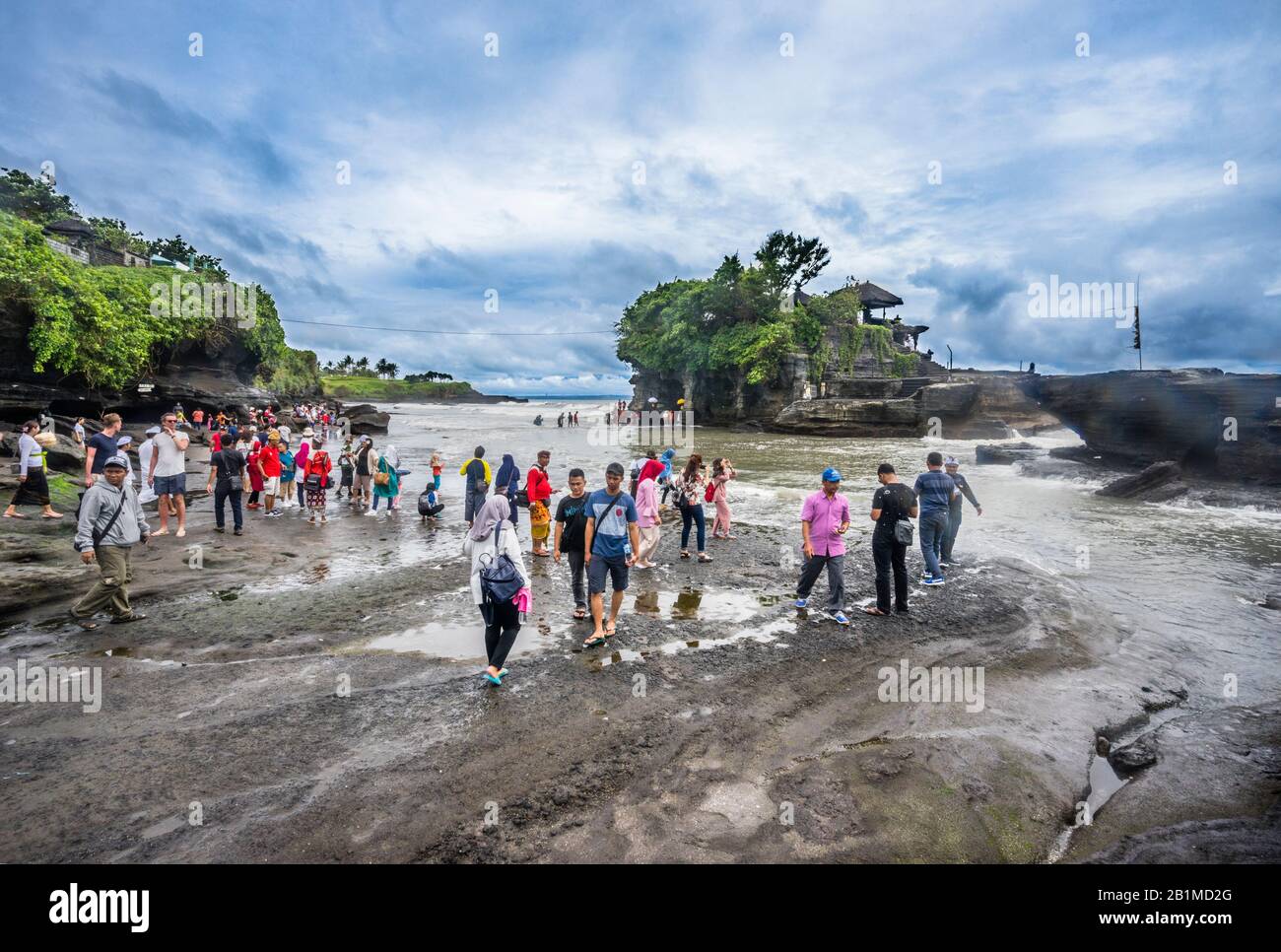 visitors and pilgrims at Tanah Lot, a rock formation off the Indonesian ...