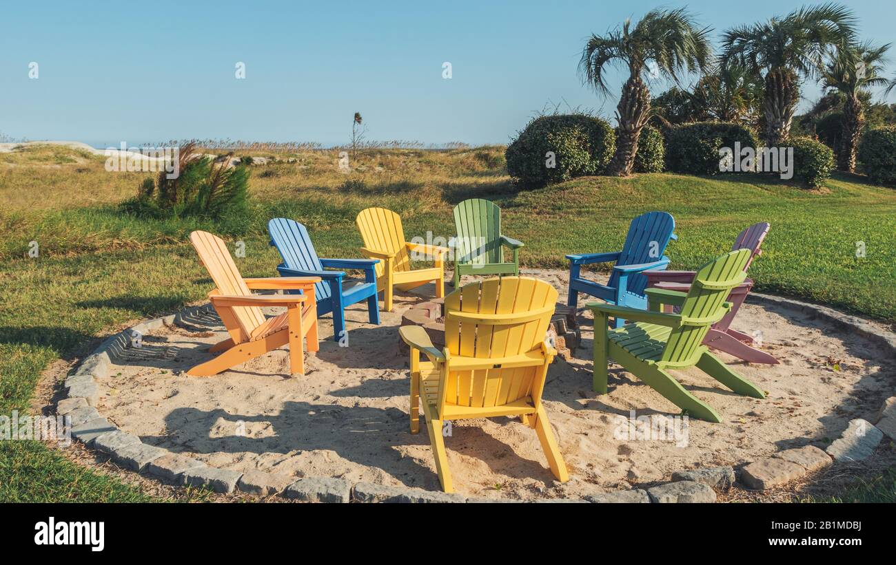 Colorful beach charis around a fire pit on the beach of Jekyll Island