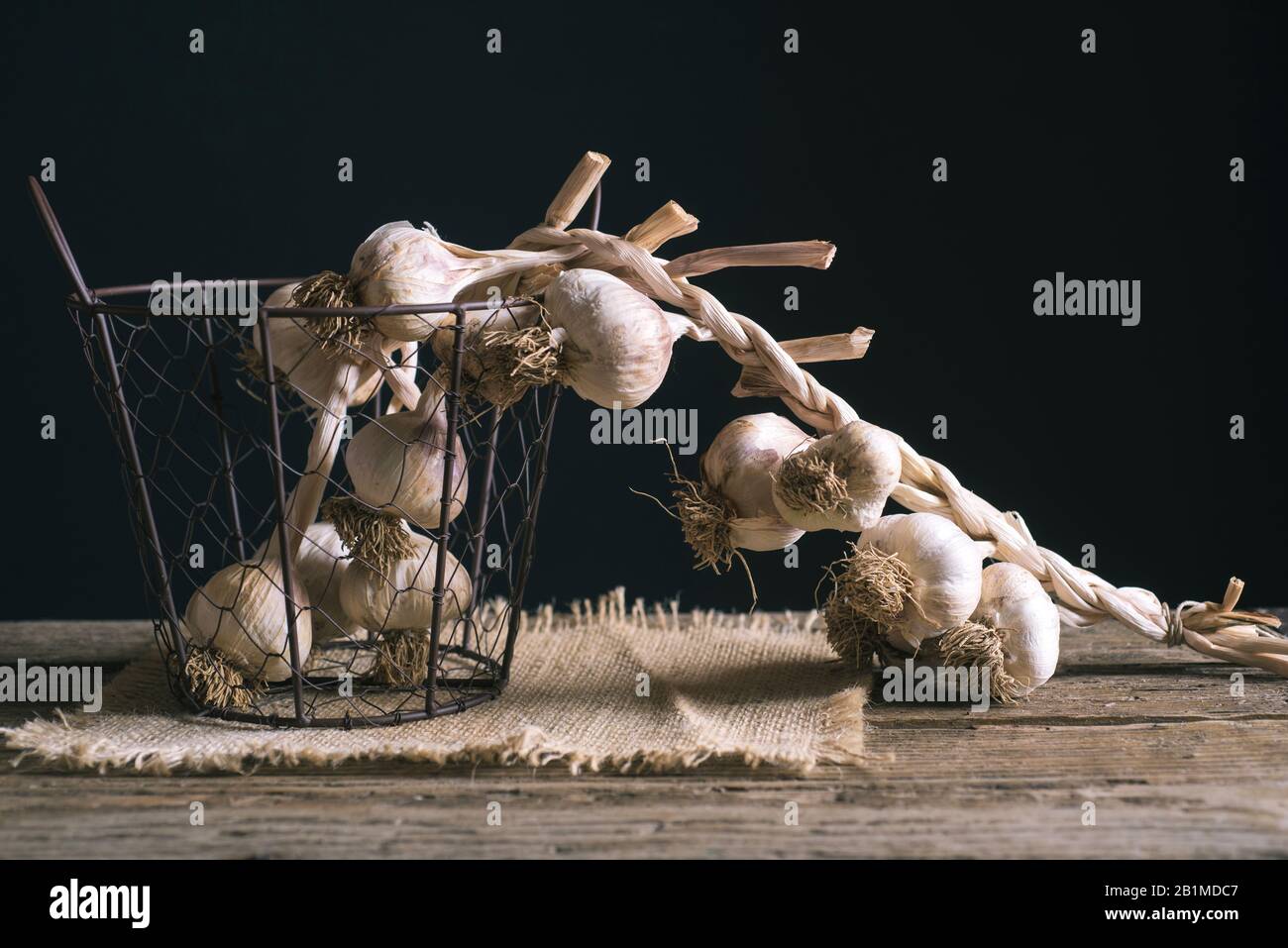 Garlic rope on dark background Stock Photo - Alamy