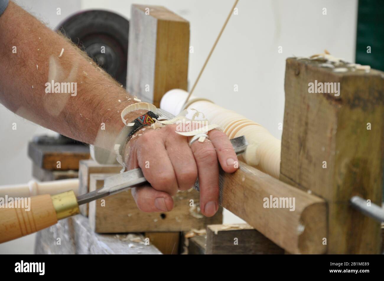Woodturning using a bodgers pole lathe to make a traditional Windsor chair leg.Fresh unseasoned wood is turned usually in situ in the wood.Photographe Stock Photo