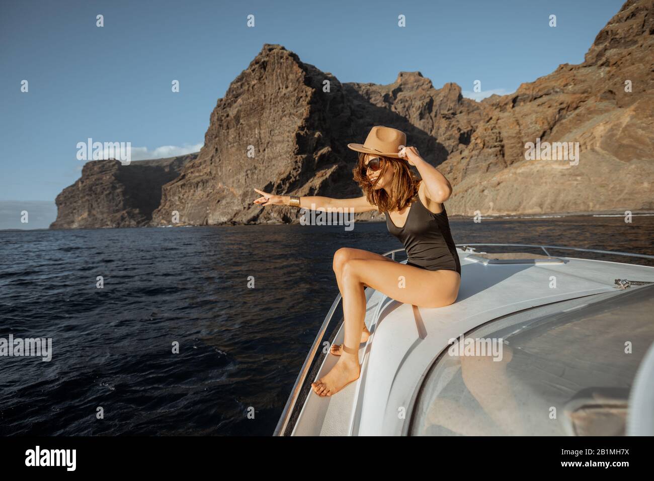 Portrait of sexy young Caucasian woman sitting on rocky coast with breasts  exposed, Stock Photo, Picture And Royalty Free Image. Pic. LPX-U21736378