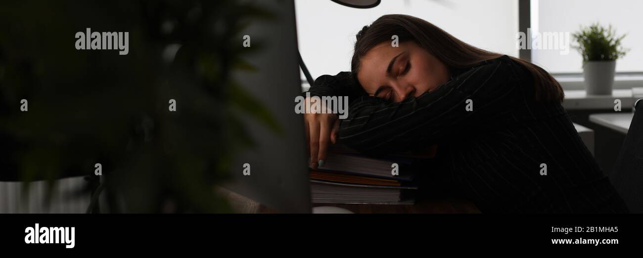 Tired woman in office Stock Photo