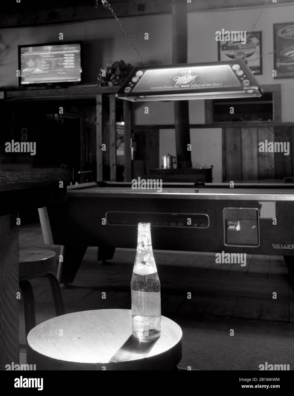 BW02225-01...WYOMING - Beer bottle on bar stool in the town of Dubois. Stock Photo