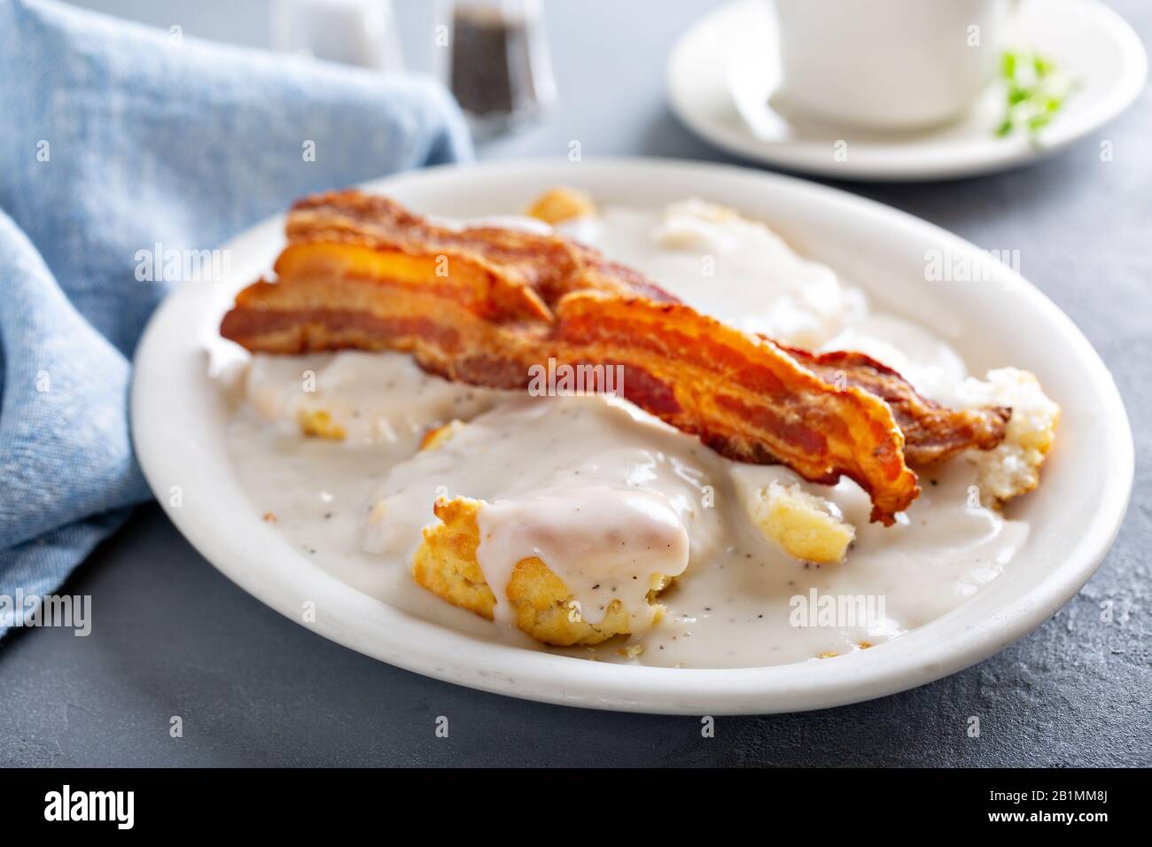 Biscuits and gravy with bacon for breakfast Stock Photo Alamy