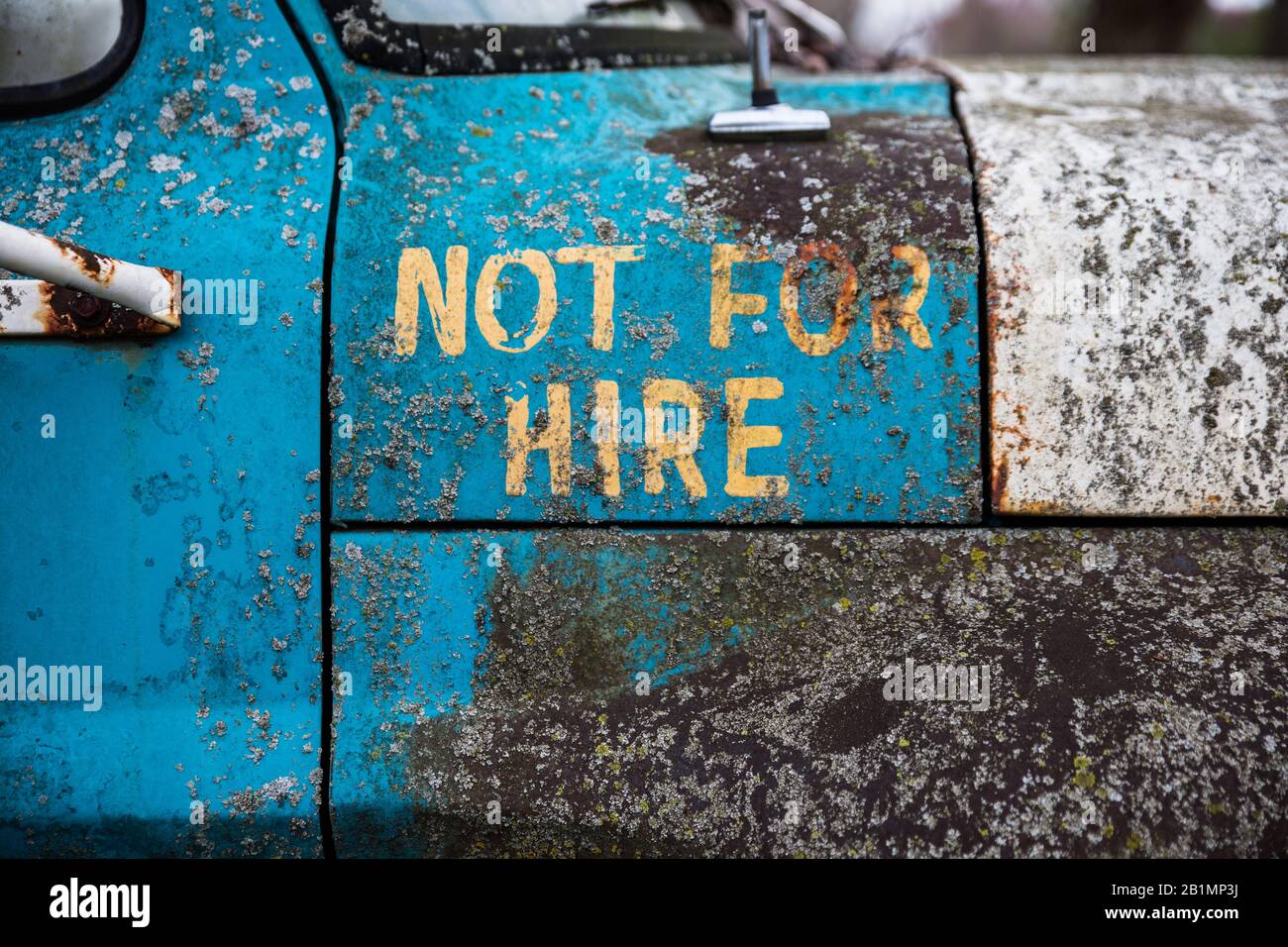 'Not For Hire' painted on the side of an old ford pickup. Stock Photo