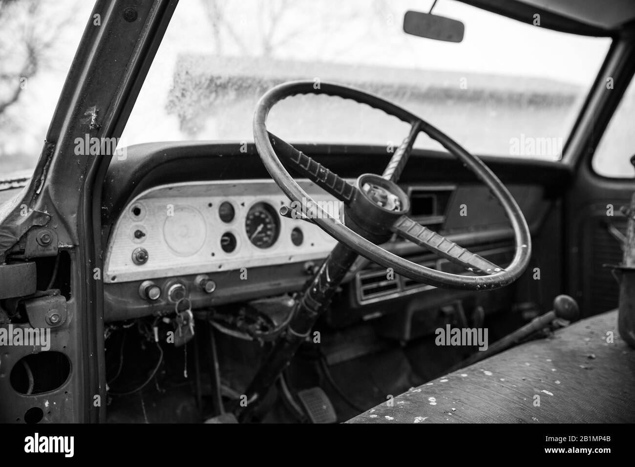 A shot of the interior of an old pickup in black and white. Stock Photo