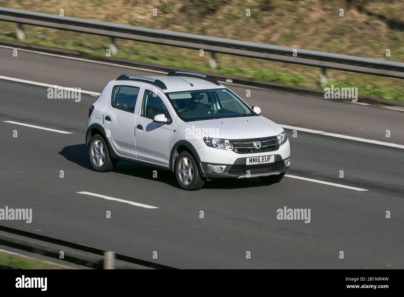 2016 Dacia Sandero Stepway Laureate White Car Petrol driving on the M6 motorway near Preston in Lancashire, UK Stock Photo