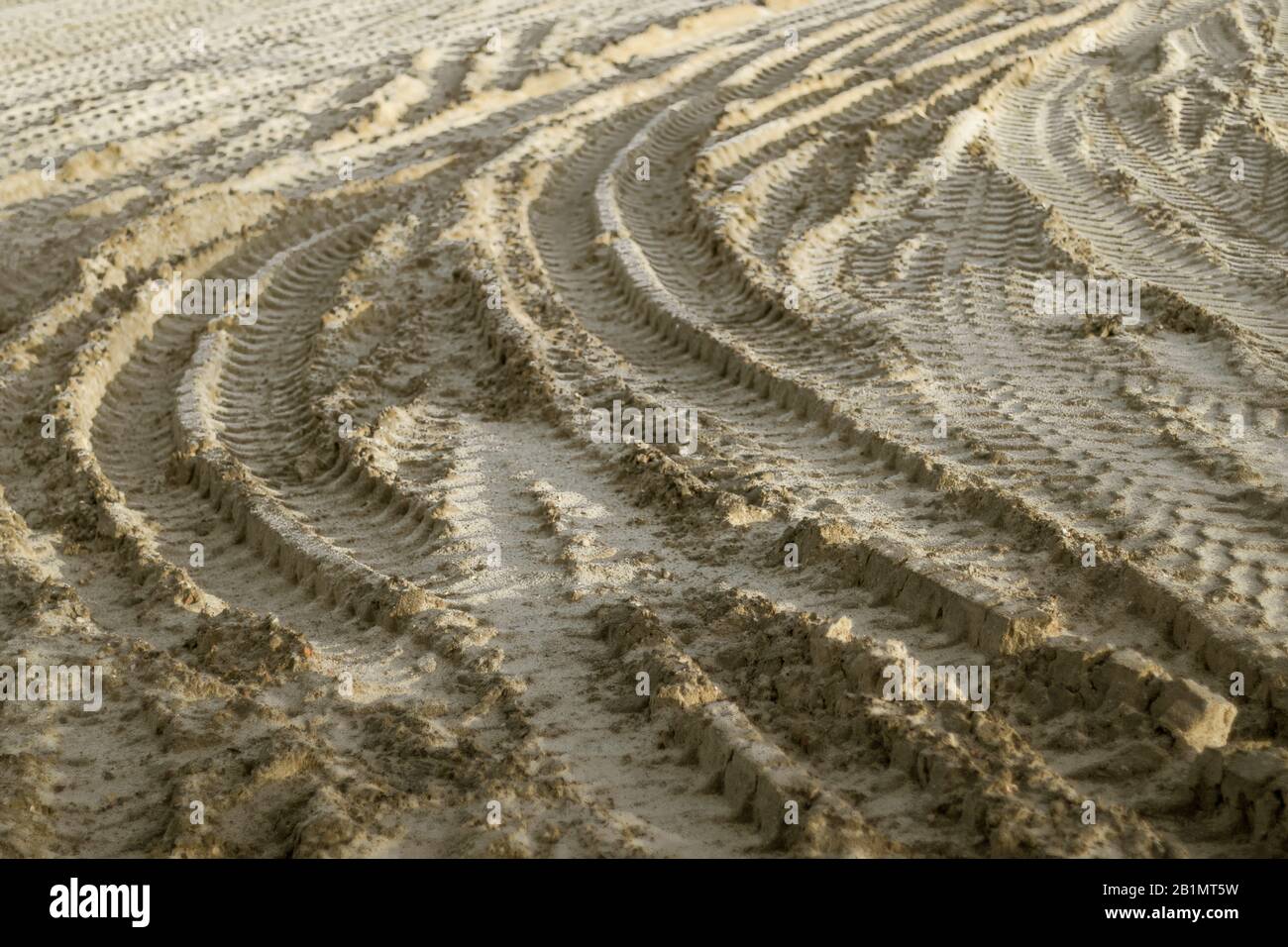 Tire tracks on sandy ground at construction yard. Royalty free stock photo. Stock Photo