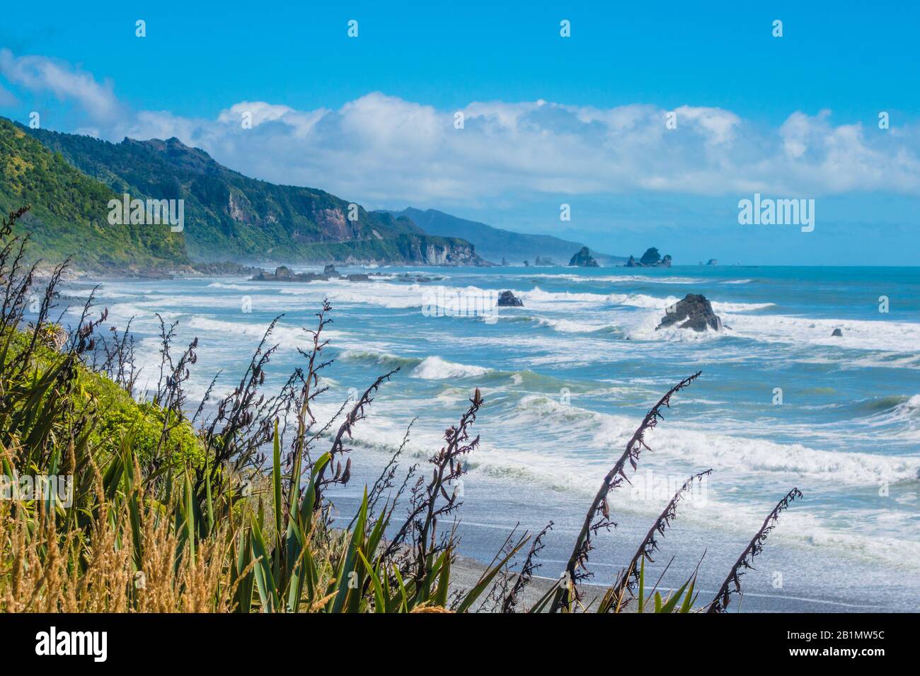 Strong current at coast of Tasmanian Sea with waves crashing at shore of New Zealand. Royalty free stock photo. Stock Photo