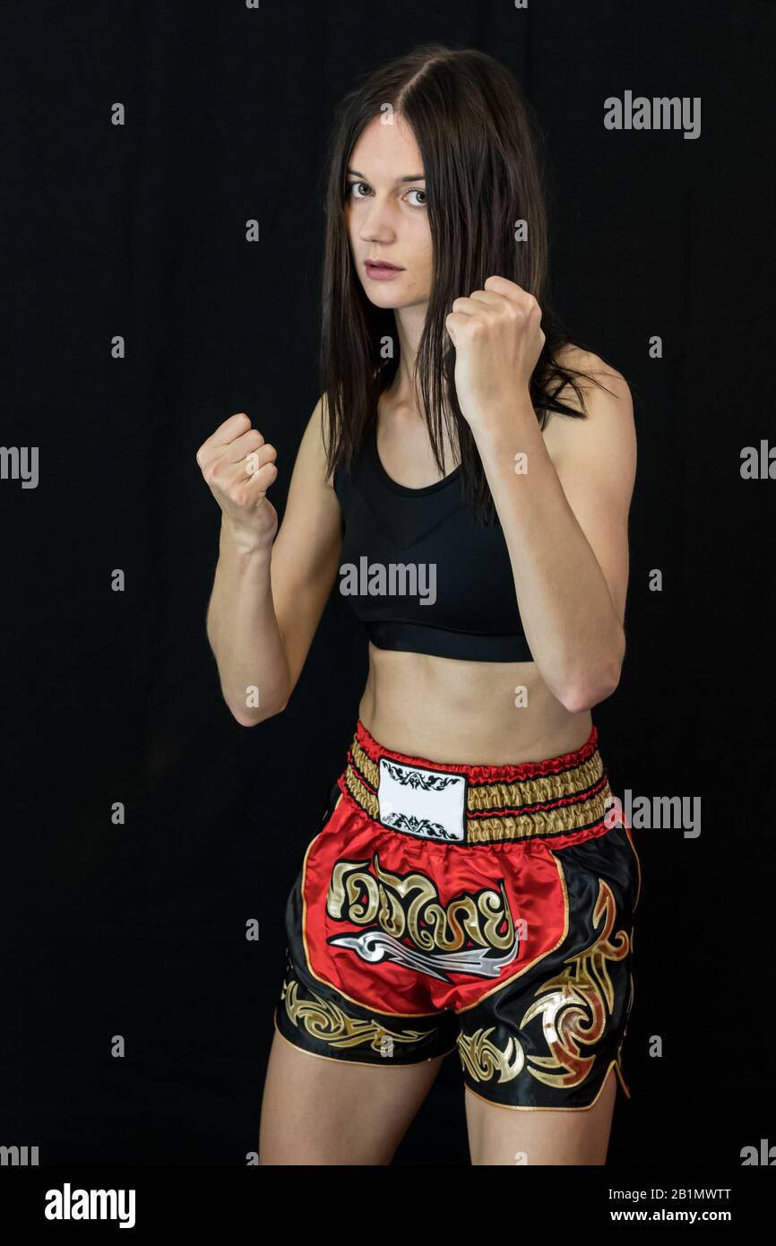 Determined boxing girl posing ready for a fight. Royalty free stock photo. Stock Photo