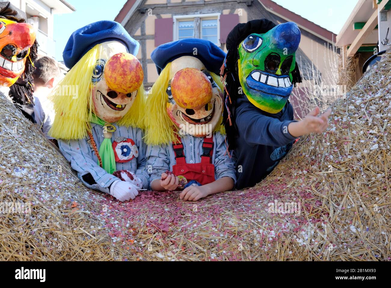 Three children wearing masks at the carnival in Allschwil, Basel landschaft, Switzerland Stock Photo