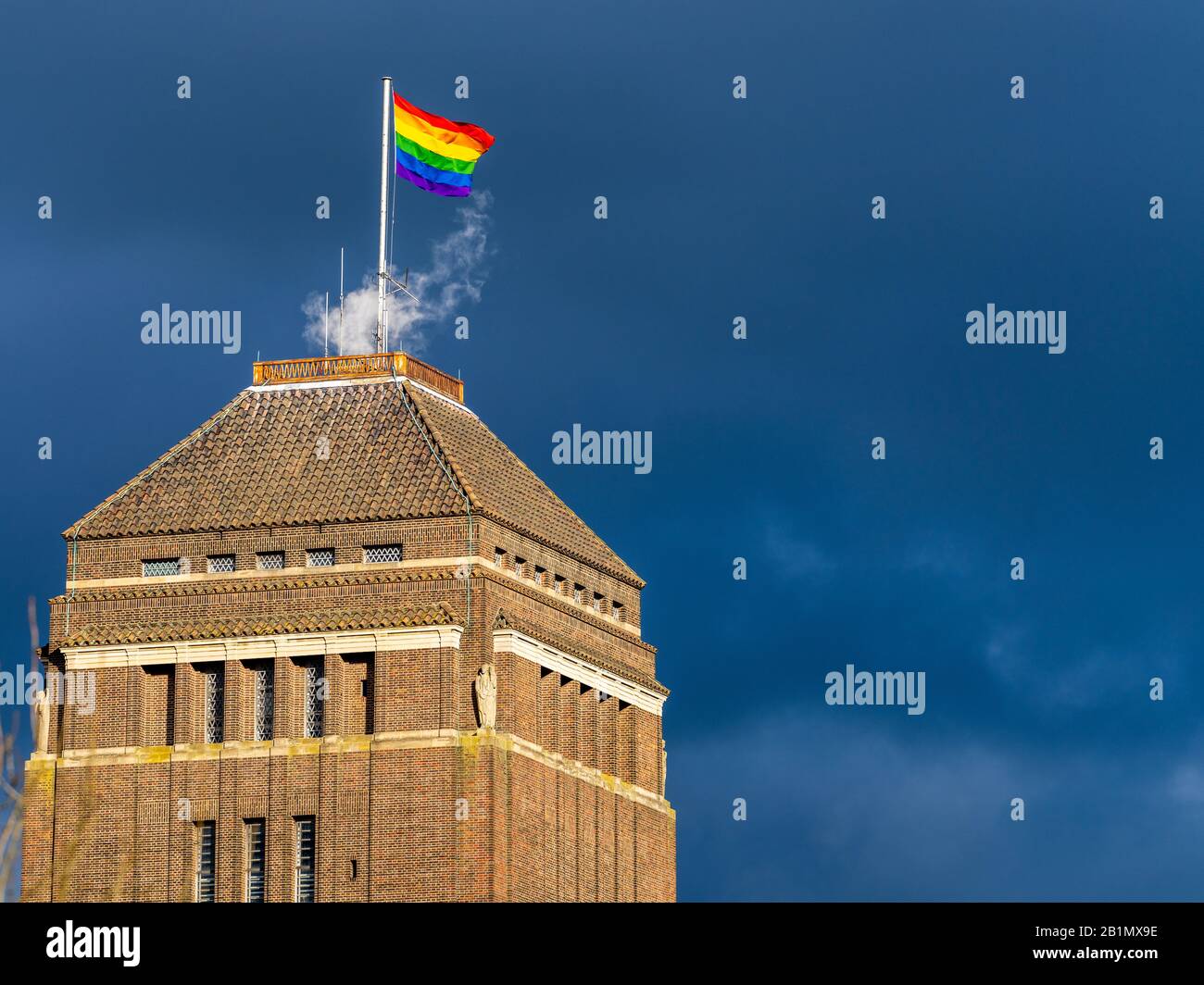 LGBT+ flag flies over the University of Cambridge library during LGBT+ History Month. LGBT Flag flies over the Cambridge University Library. Stock Photo