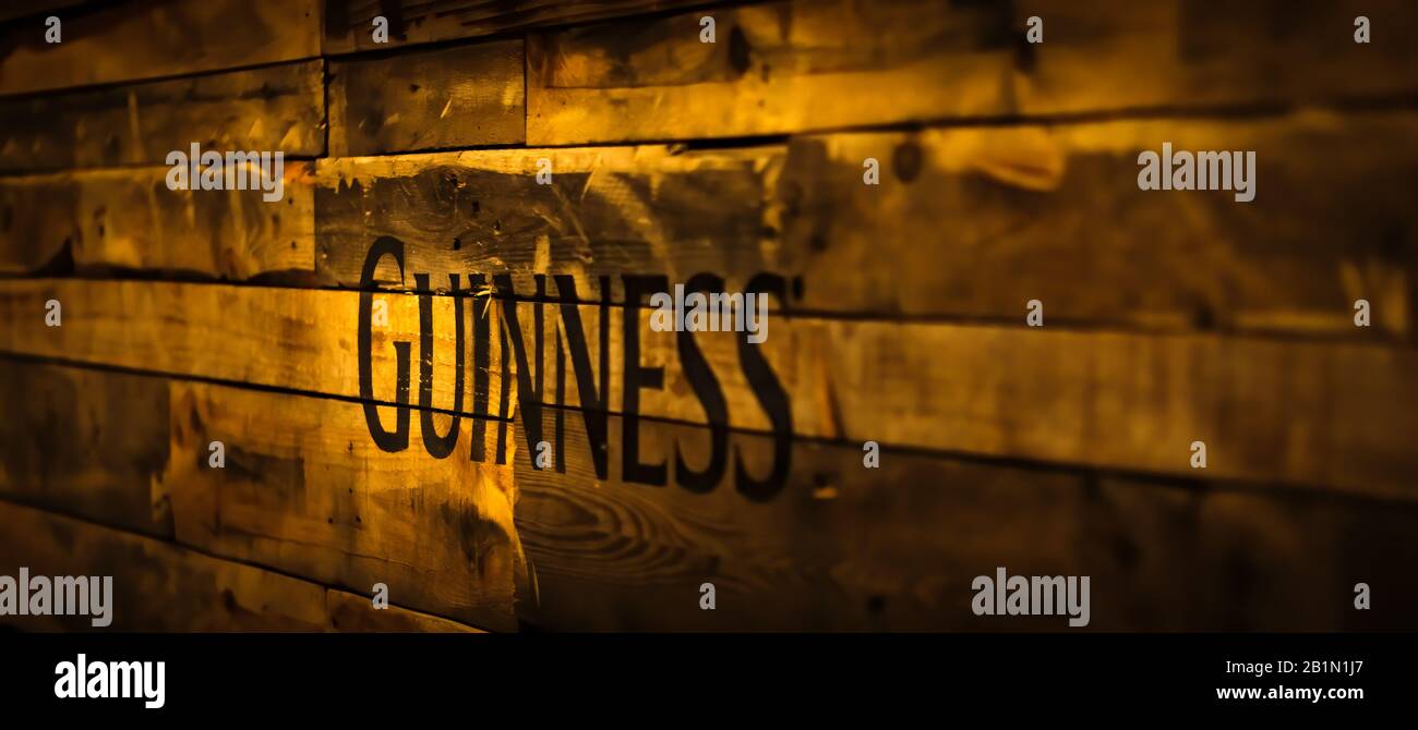 Dublin, Ireland, December 2017 Selective focus on Guinness sign in vintage or grungy style on wooden planks. Guinness is iconic Irish beer Stock Photo