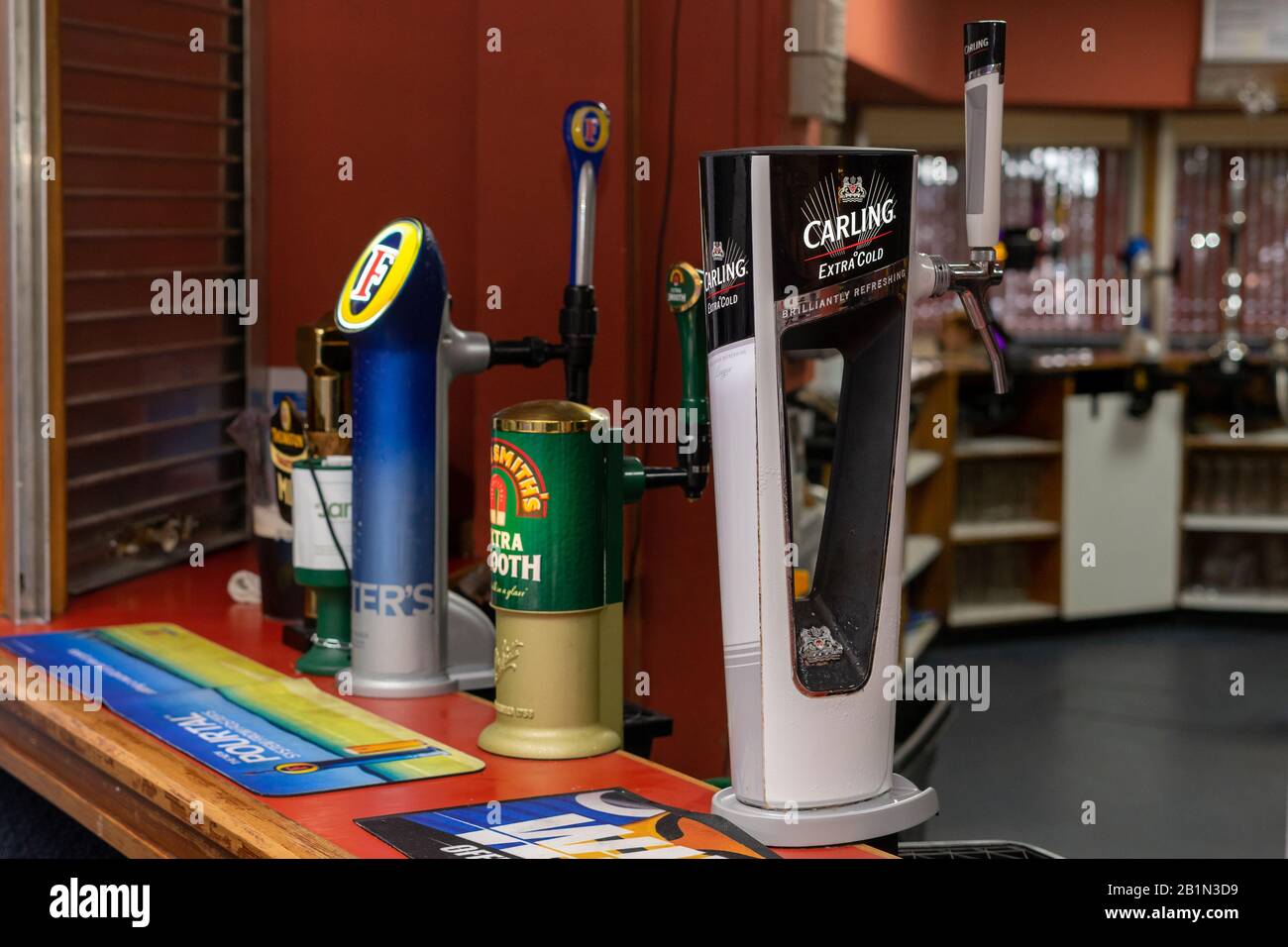 various brands of beer pump on a bar inside a pub Stock Photo Alamy