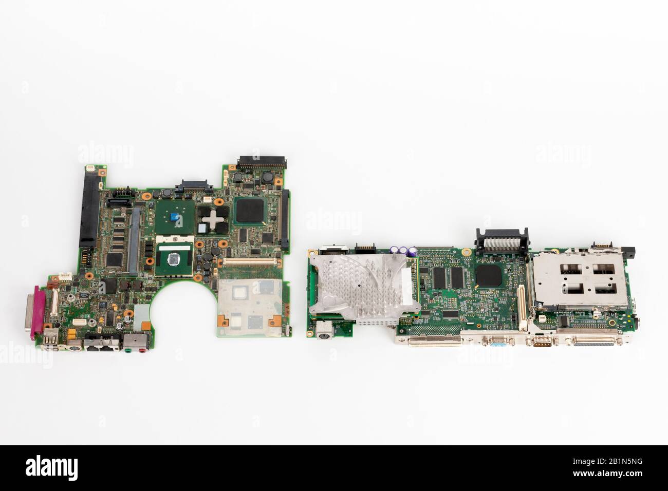 Comparing two laptop mother boards,  one  from 2003, one from 1999. Stock Photo