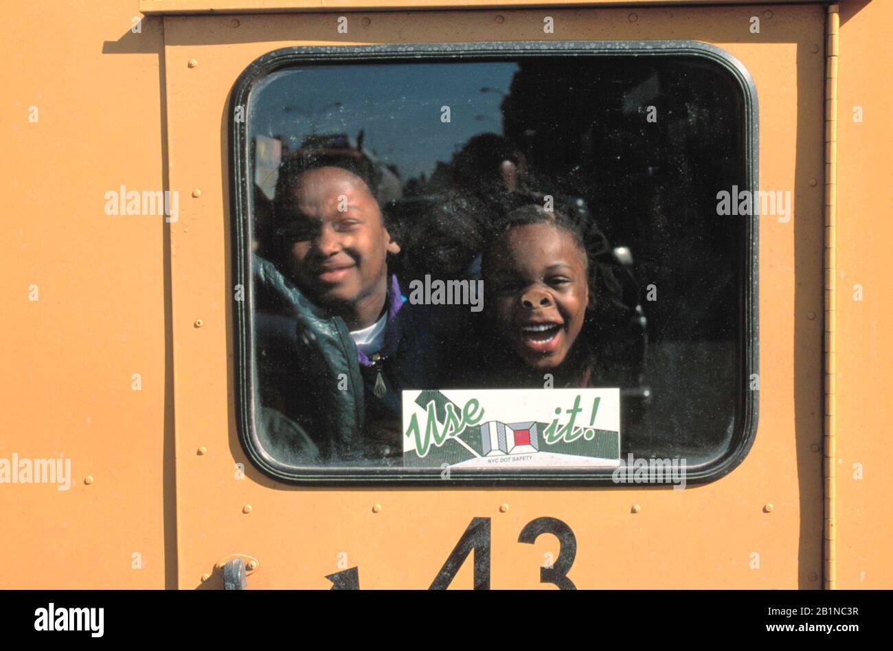 Children having fun aboard school bus, Brooklyn, NY Stock Photo