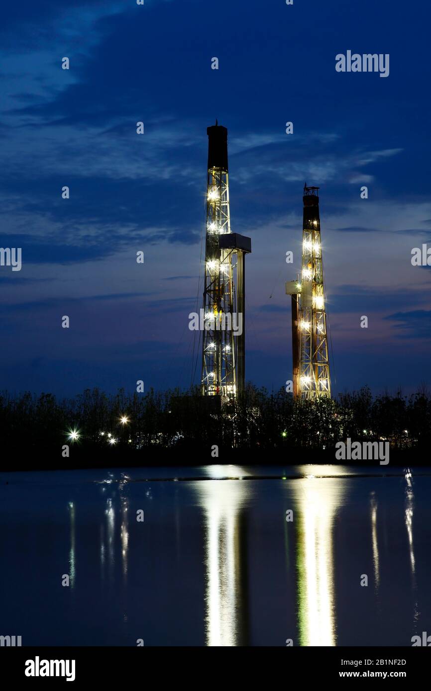 In the evening of oilfield derrick Stock Photo Alamy