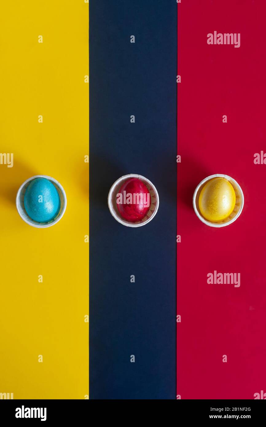 Minimalistic easter background. Colorful easter eggs on the multicolored background. View from above. Top view. Flat lay image Stock Photo