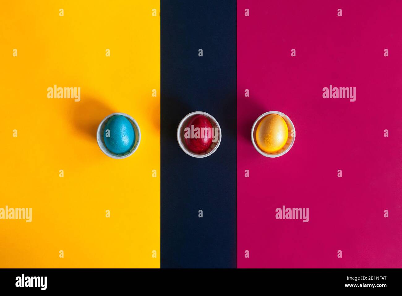 Minimalistic easter background. Colorful easter eggs on the multicolored background. View from above. Top view. Flat lay image Stock Photo