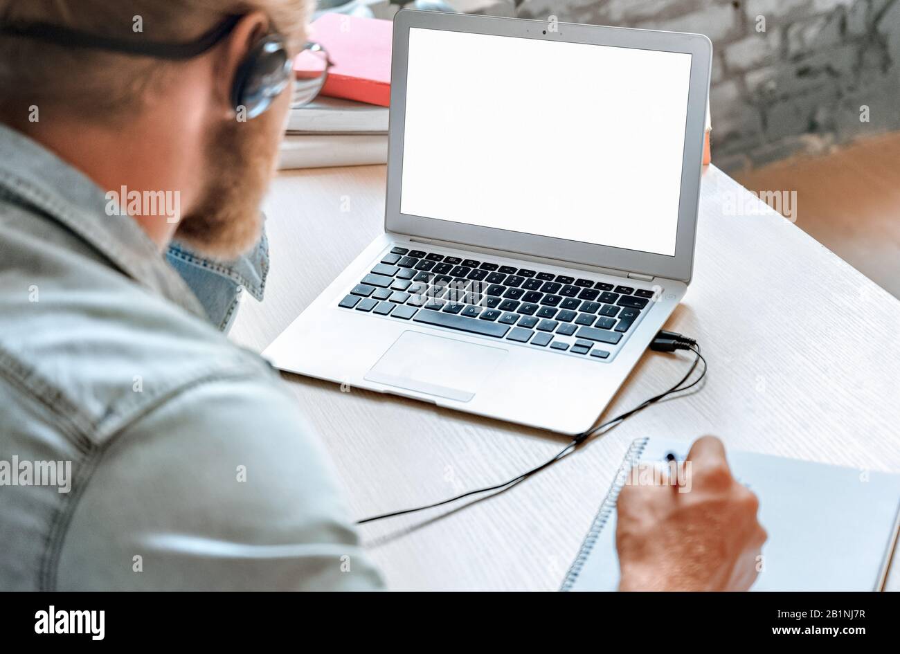 Close up student use laptop make notes watching webinar mock up screen. Stock Photo