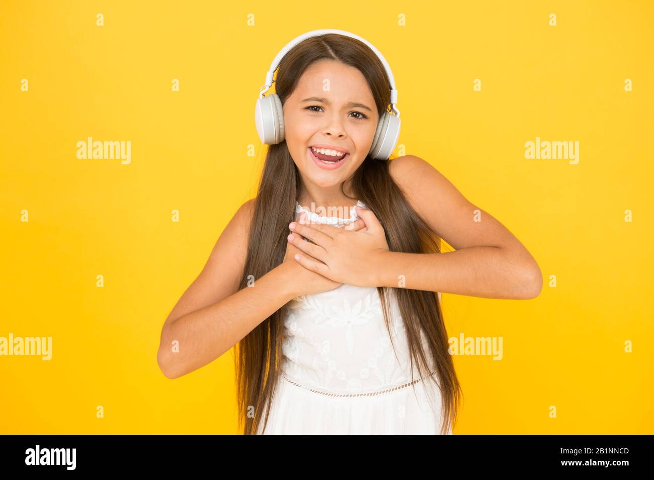 Happy child enjoy listen to music in headphones. small girl enjoying DJ