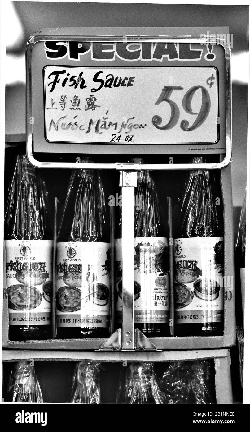 Chinese fish sauce for sale in Los Angeles with both languages used to make the sale clear bilingual Stock Photo